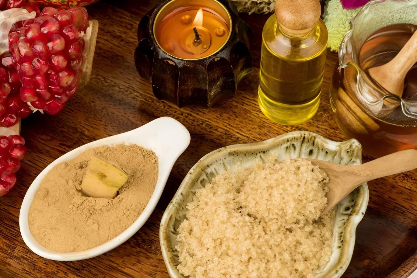 Close-up of Spa Ingredients: Pomegranate, Candle, Oil, Honey, Ground Powder, and Brown Sugar in Decorative Dishes on a Wooden Tray — C & D Manufacturing In Caboolture, QLD