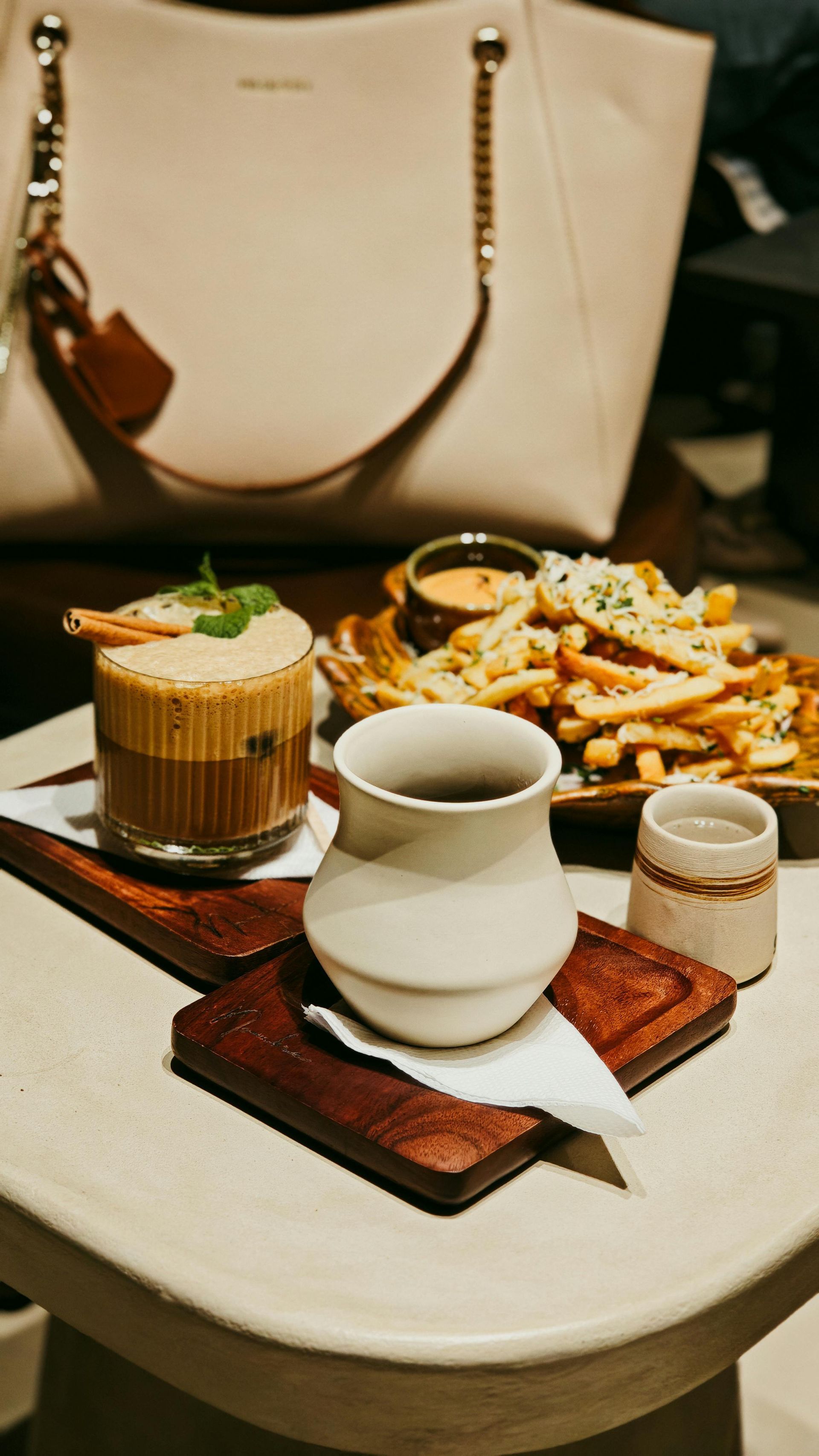 Tacos with salmon and mango salsa, lime slices, on a green plate. Wooden table.