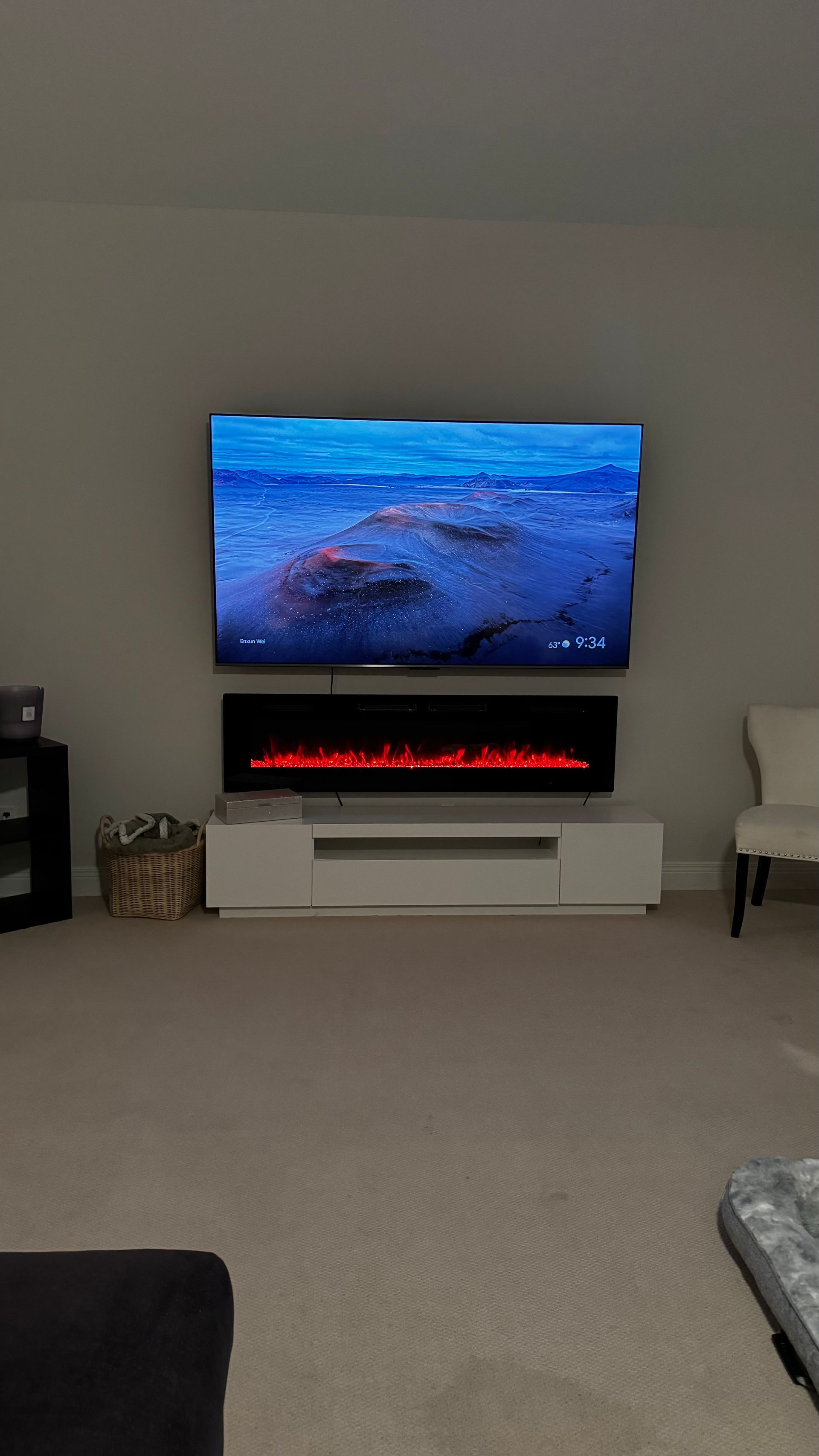 A living room with a flat screen tv and a fireplace.
