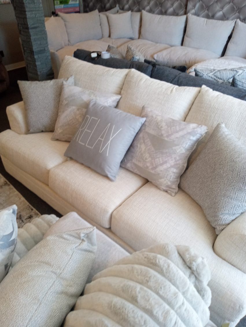 A couch with a pillow that says ely on it