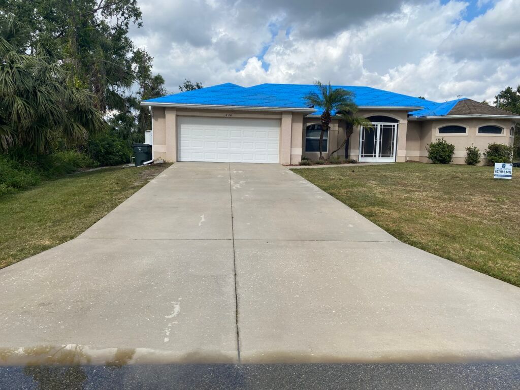 A house with a cleaned concrete driveway - Port Charlotte, FL - MD Pressure Cleaning & Soft Wash