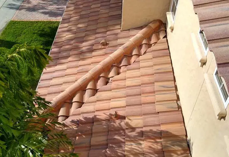 A roof with a chimney on it and a tree in the background after cleaning - Port Charlotte, FL - MD Pressure Cleaning & Soft Wash