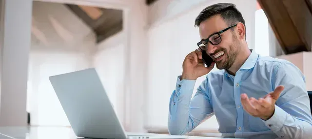 Duplicate of man on phone talking who looks fulfilled by taking a client focused approach to financial planning or advising