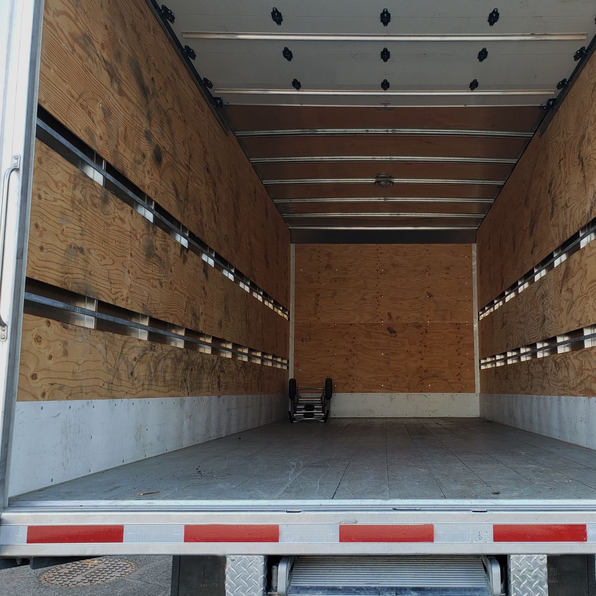 An empty truck with a ladder in the back