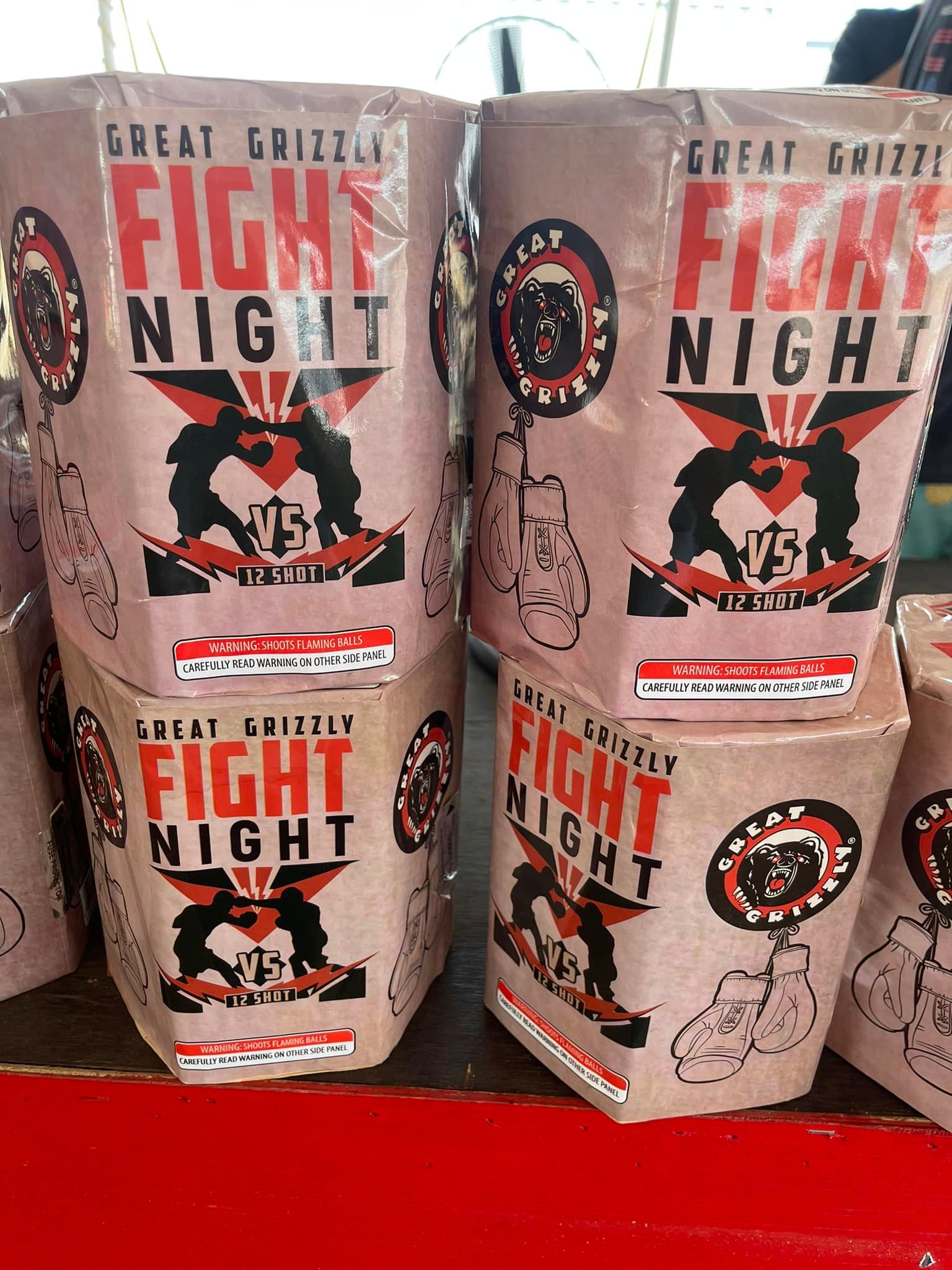 A stack of fight night fireworks sitting on top of each other on a table.