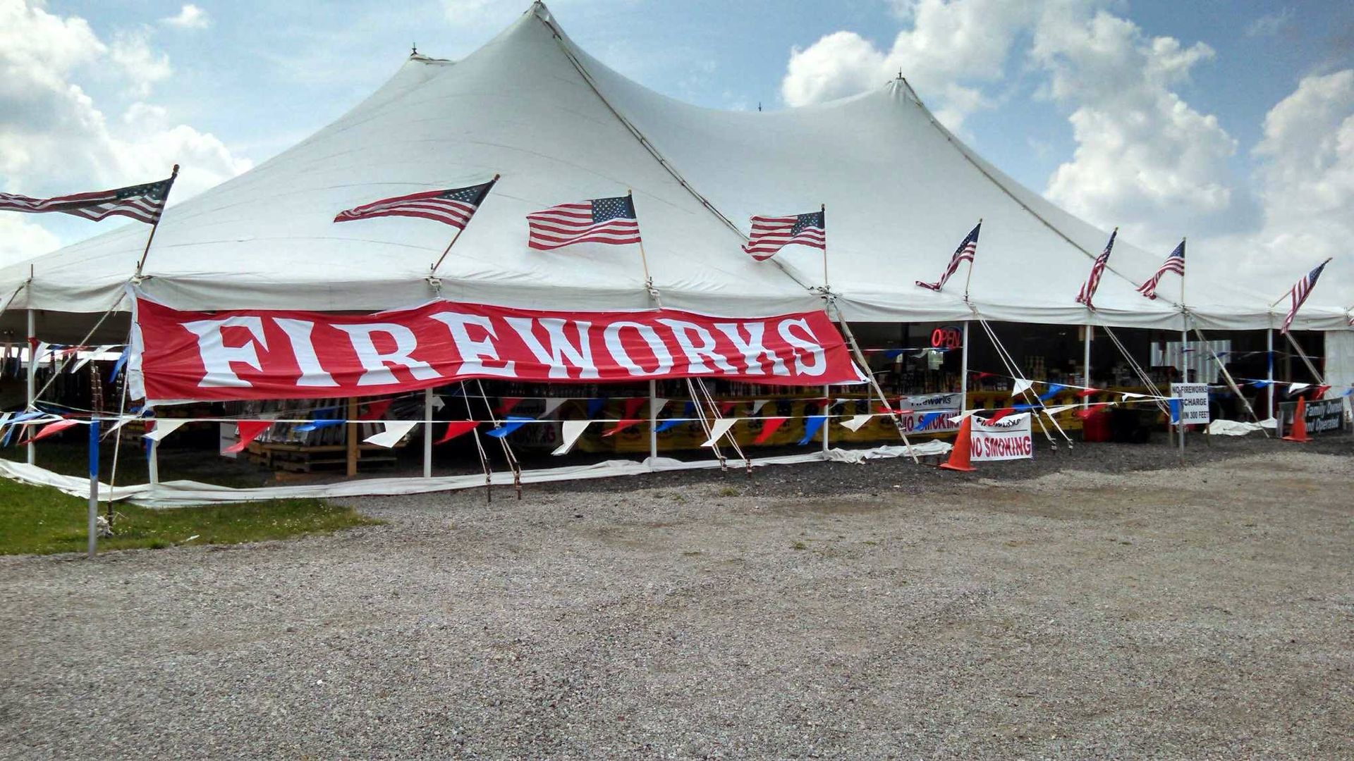 A large white tent with a red sign that says fireworks