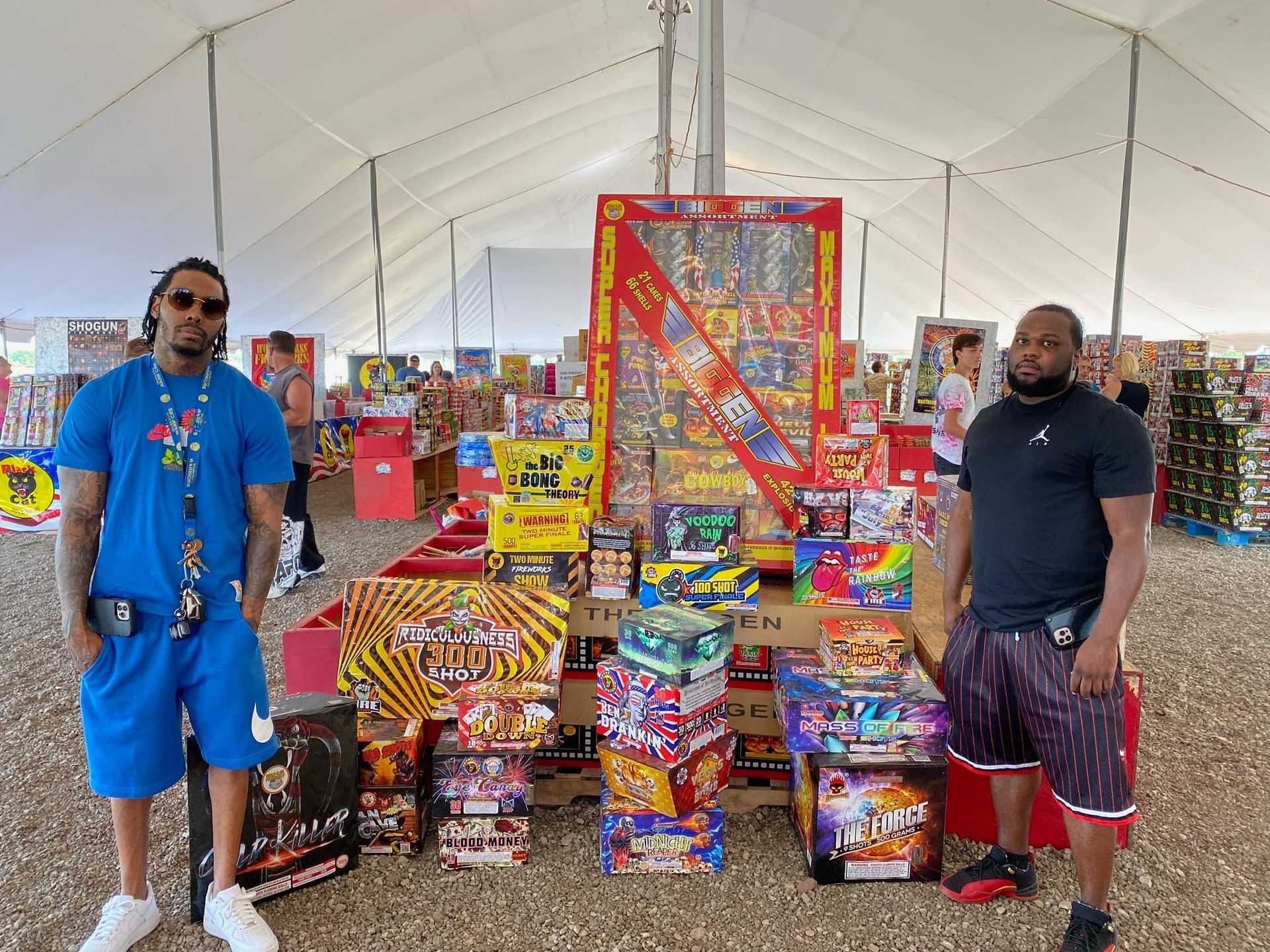 Two men are standing in front of a display of fireworks.