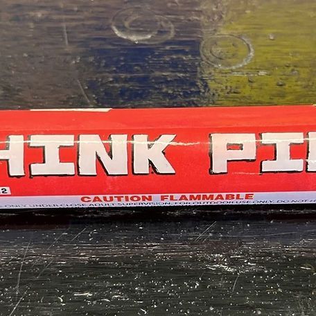 A can of hink pi sits on a table