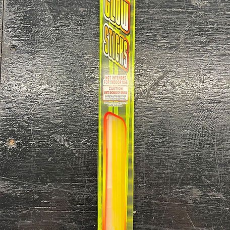 A glow stick is sitting on top of a wooden table.