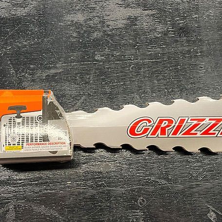 A close up of a chainsaw blade on a table.