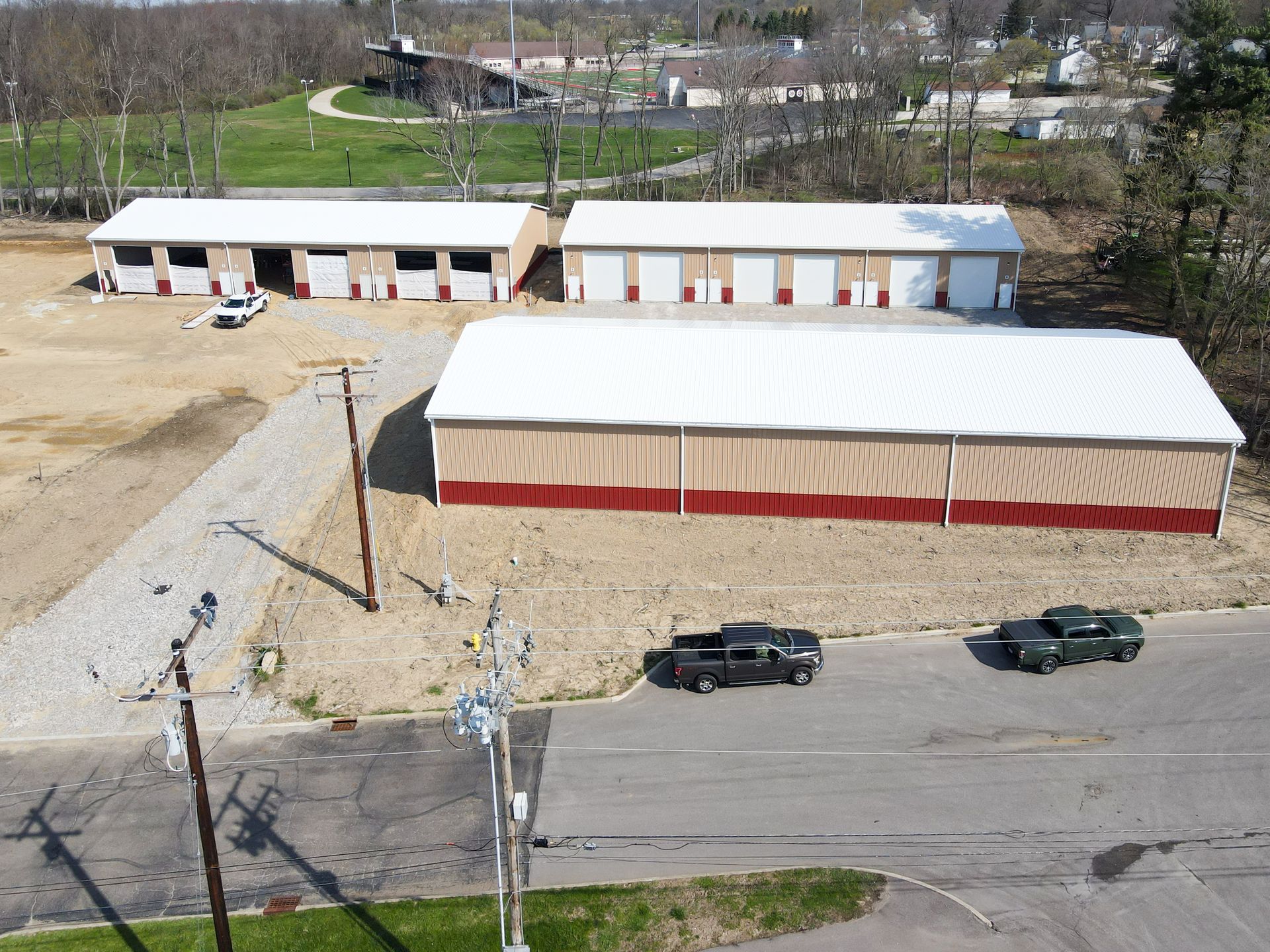 Warehouse interior with forklifts, pallets of goods, and high shelving.