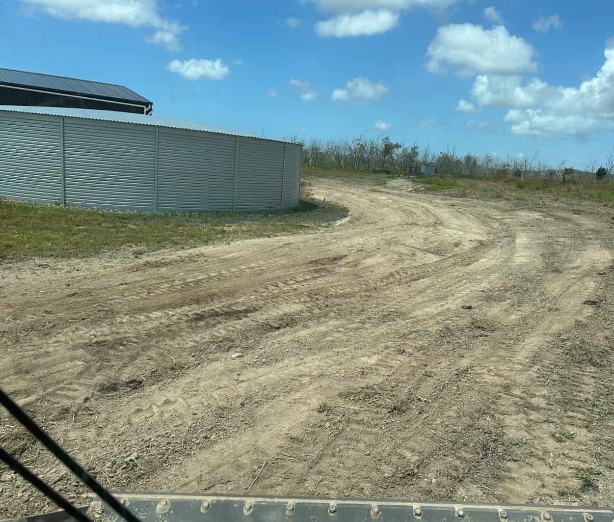 A Dirt Road With A Fence In The Background — AMW Contracting Co In Cobraball, QLD