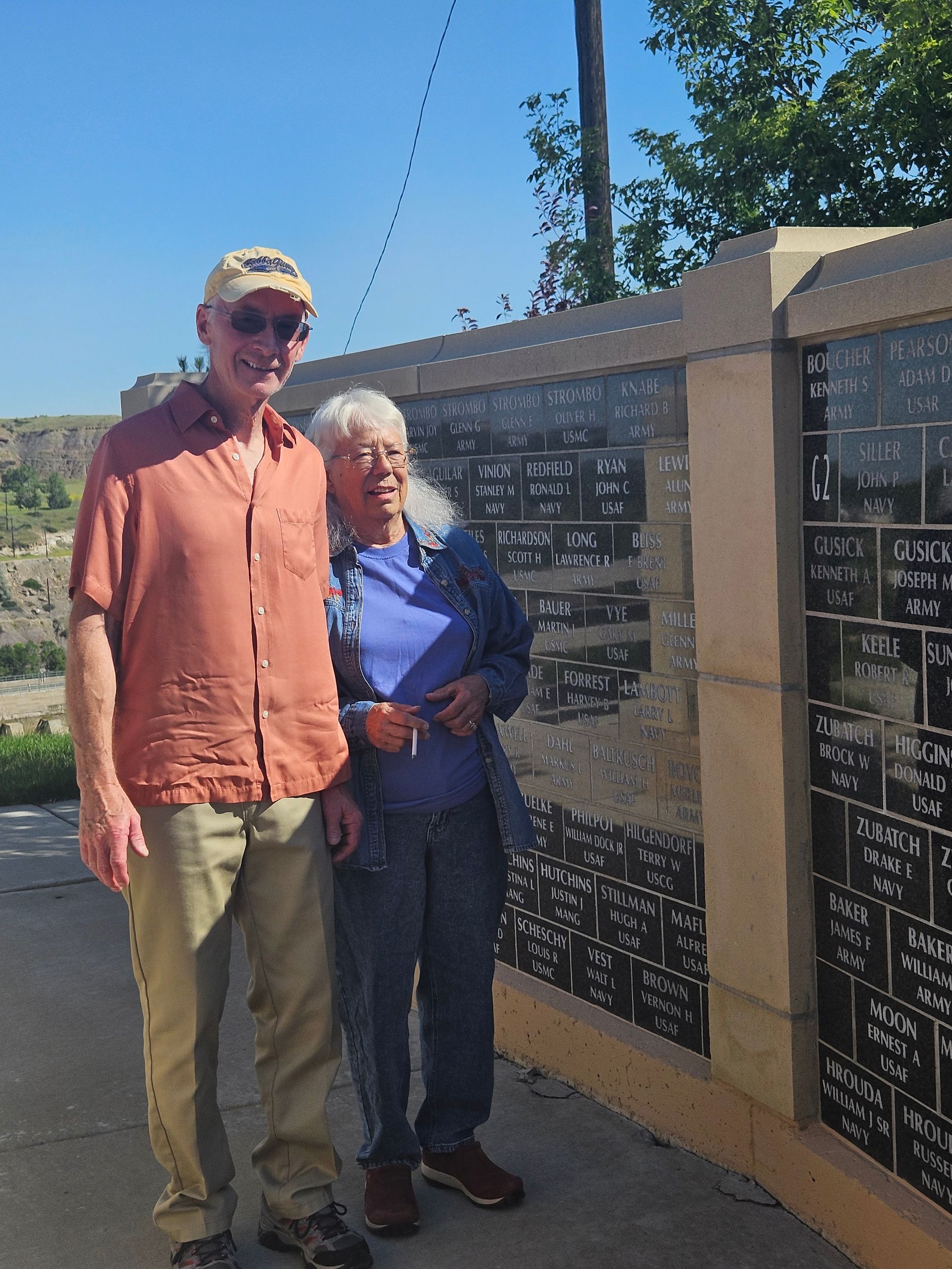 A man and a woman standing in front of a wall