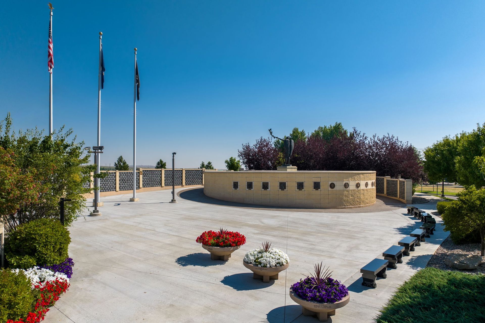 A park with flowers and flags on a sunny day