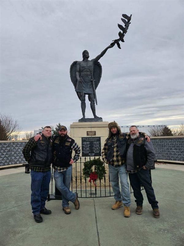 A group of men standing in front of a statue