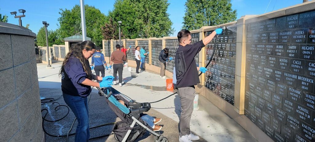 A group of people are working on a wall.