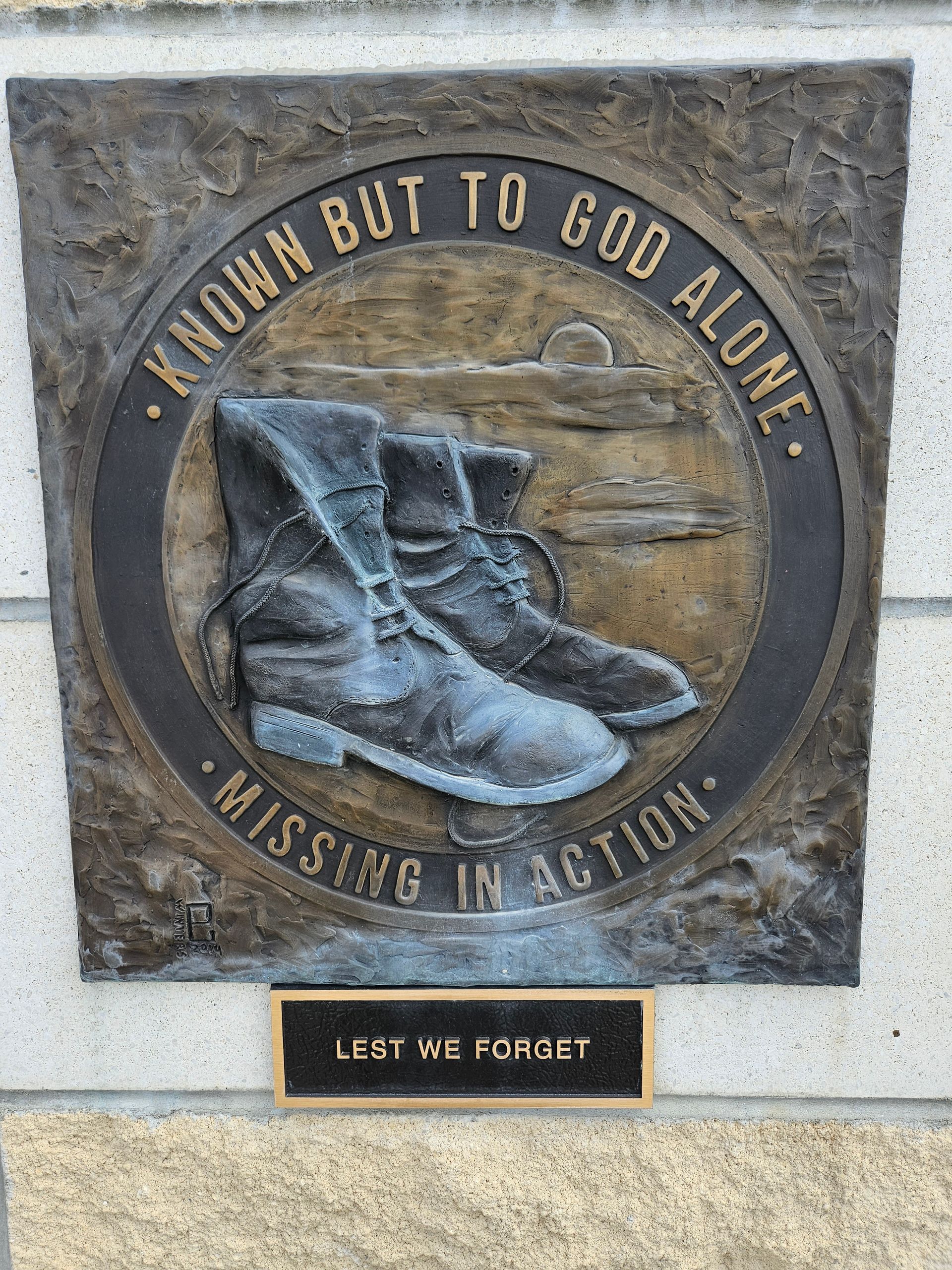 A plaque with a pair of boots on it that says `` known but to god alone ''.