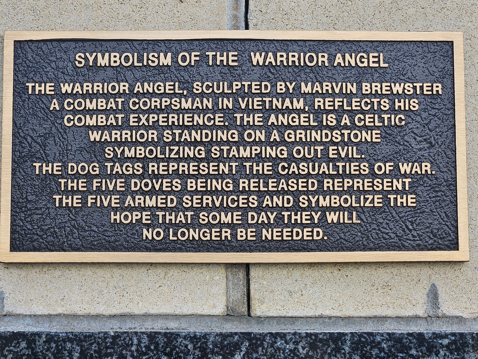 A plaque on a wall that says symbolism of the warrior angel