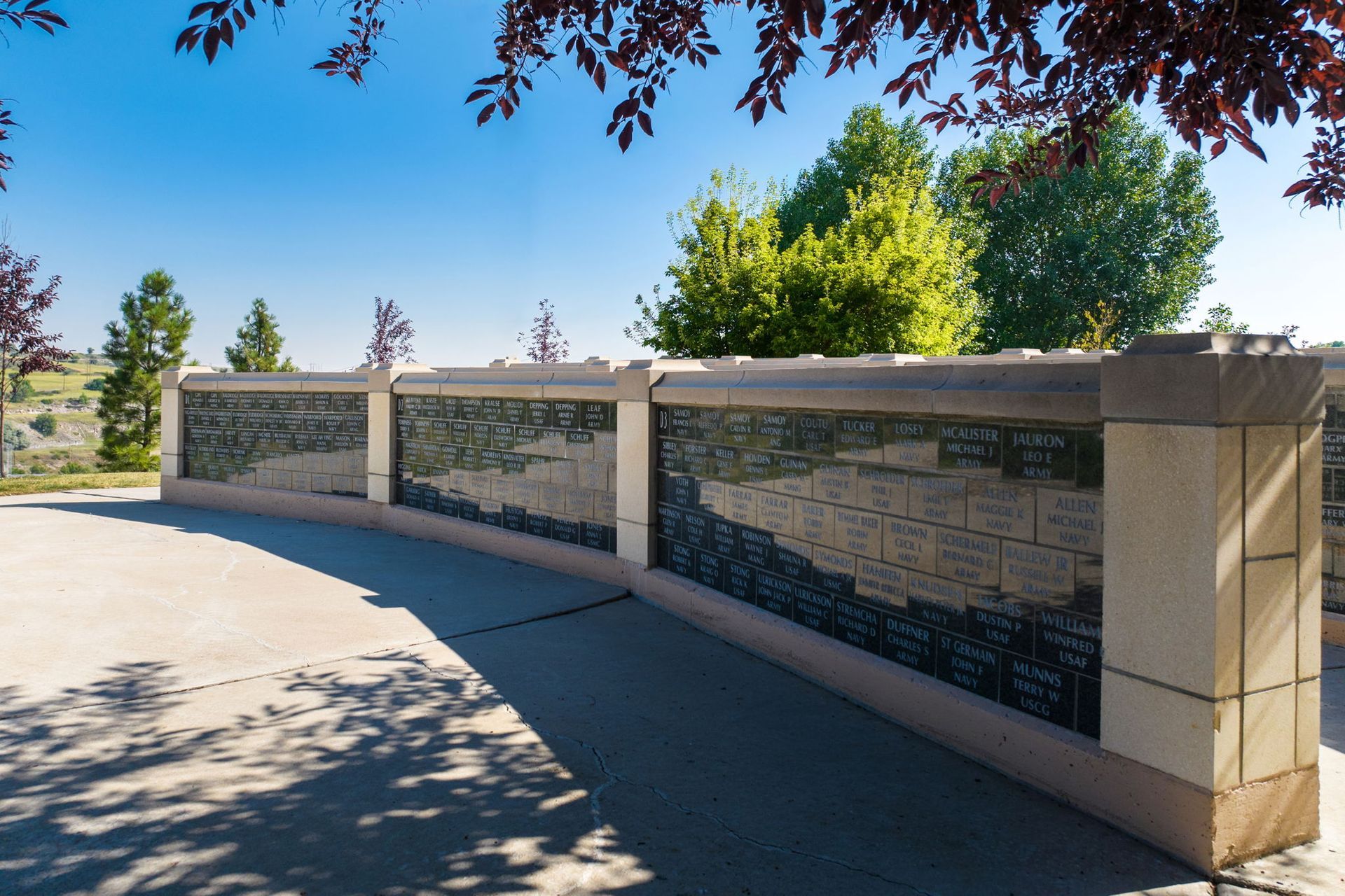 A large stone wall with a lot of names on it