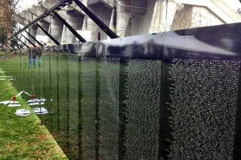 A fence with a lot of names on it