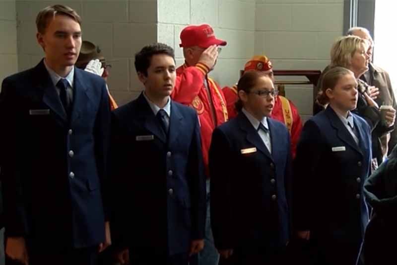 A group of people in military uniforms are standing in a line