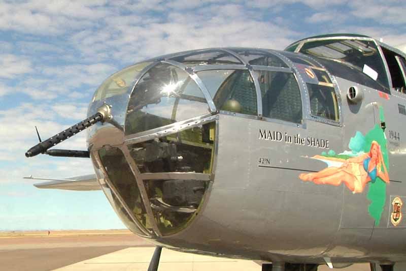 A silver airplane with a painting of a woman on the side