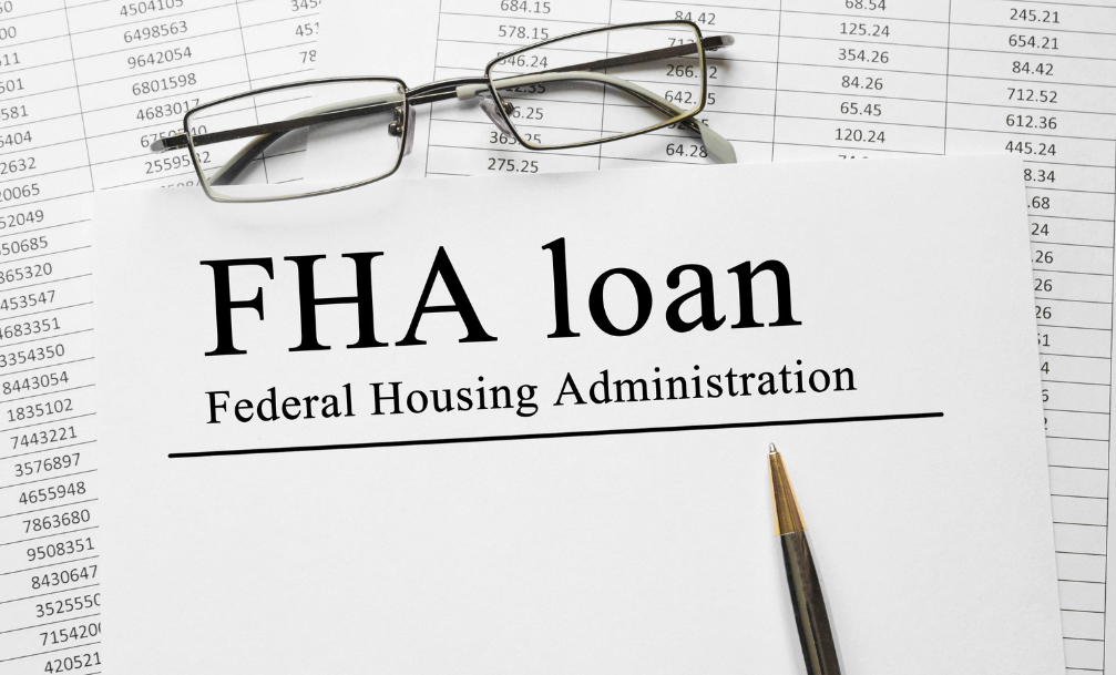 A pair of glasses is sitting on top of a federal housing administration loan form.