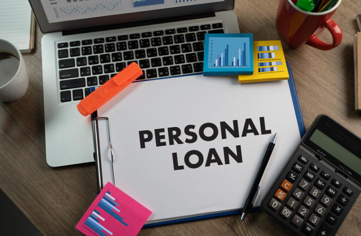 A clipboard with the word personal loan written on it.