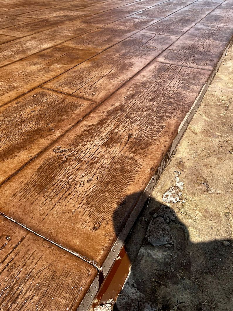 A close up of a concrete floor with a shadow of a person on it.