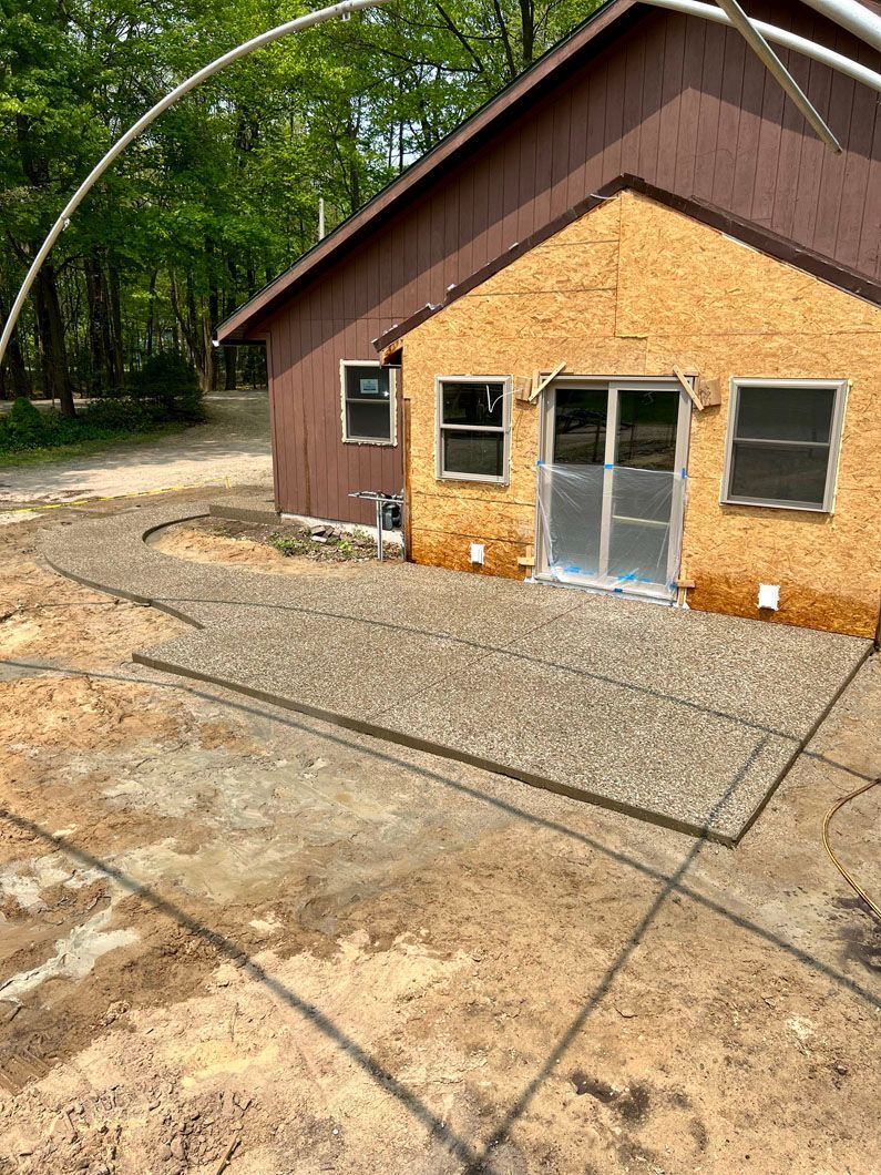 A house with a concrete patio in front of it.