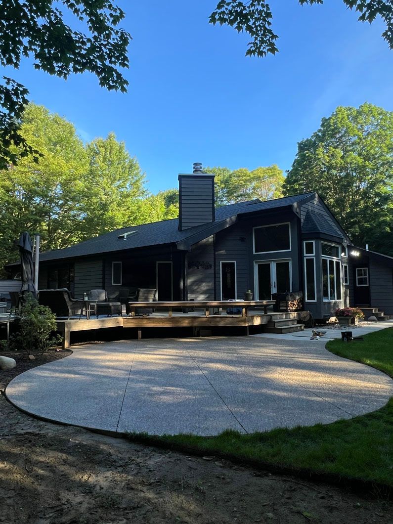 A large house with a concrete driveway leading to it