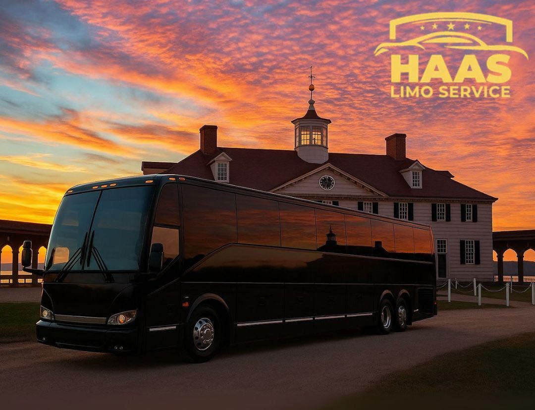 Black limo bus in front of a building at sunset with 