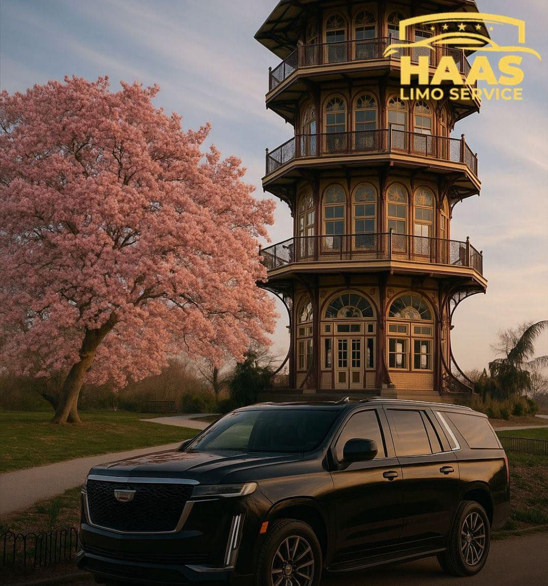 Black SUV parked near the Japanese Tea Garden, with a cherry blossom tree and a tower, Haas Limo Service logo visible.