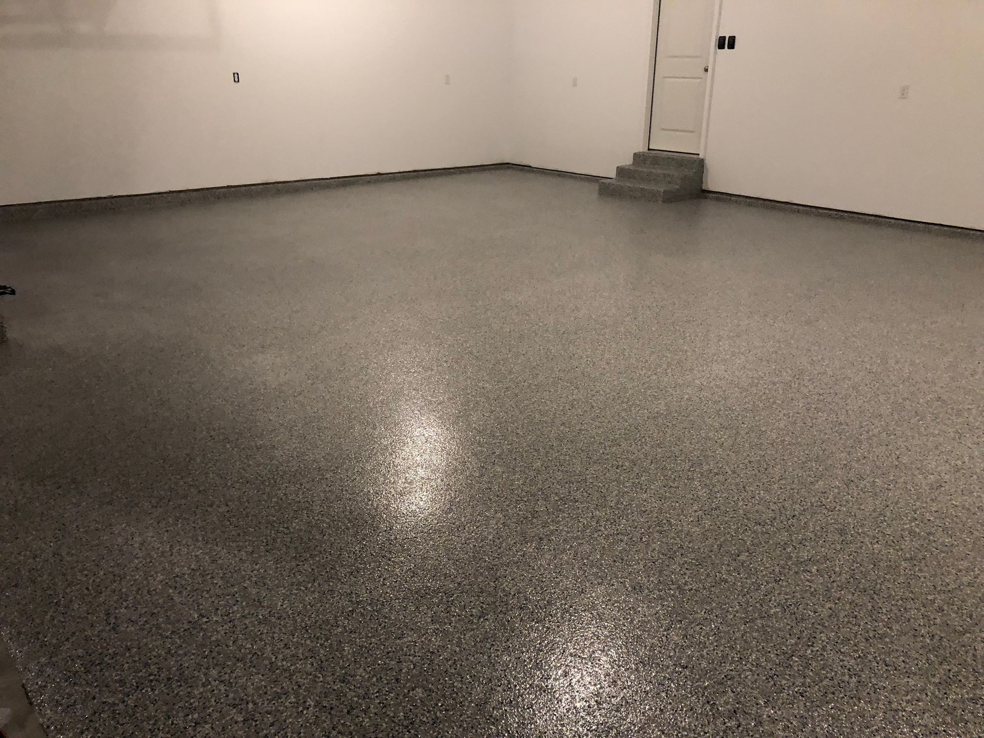 A garage with a shiny floor and white walls.