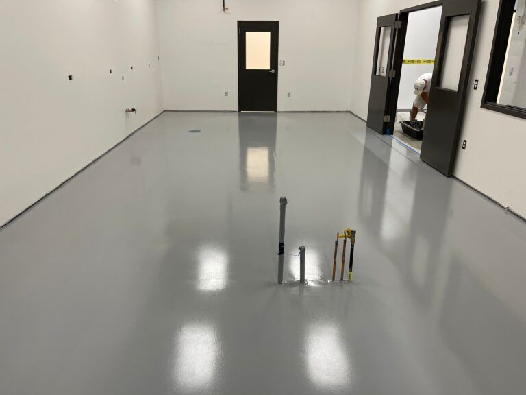 A room with a gray floor and white walls