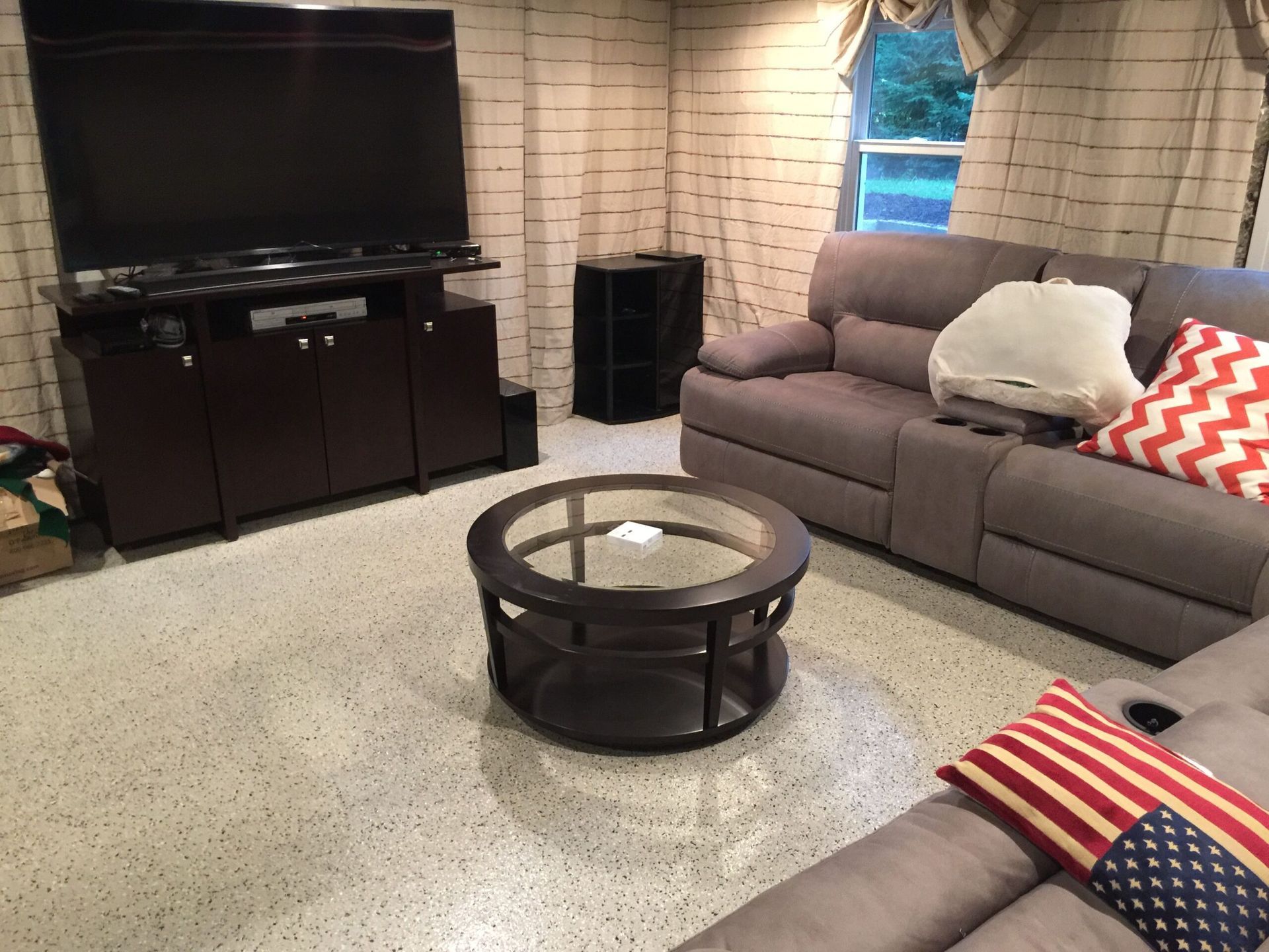 A living room with a couch a coffee table and a flat screen tv