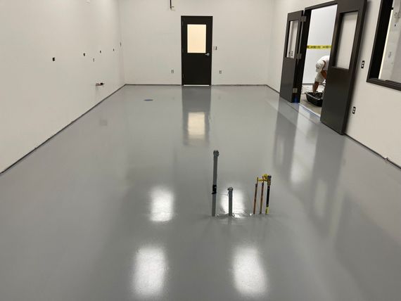 A large room with a gray floor and white walls.