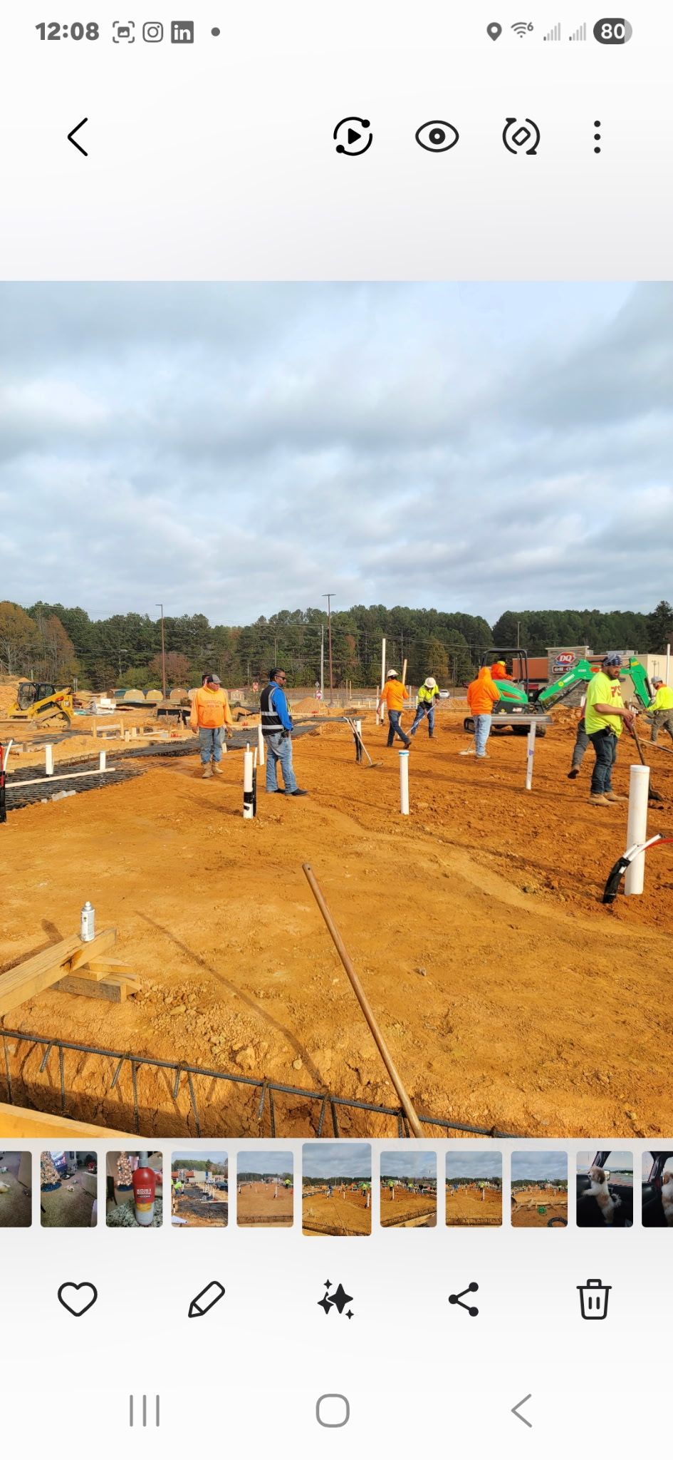 A person in a checkered shirt adjusts valves on plumbing equipment, likely for maintenance.