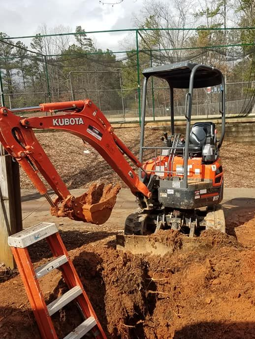 Plumber using a plunger in a bathroom, smiling. Plumber using a plunger in a bathroom, smiling.