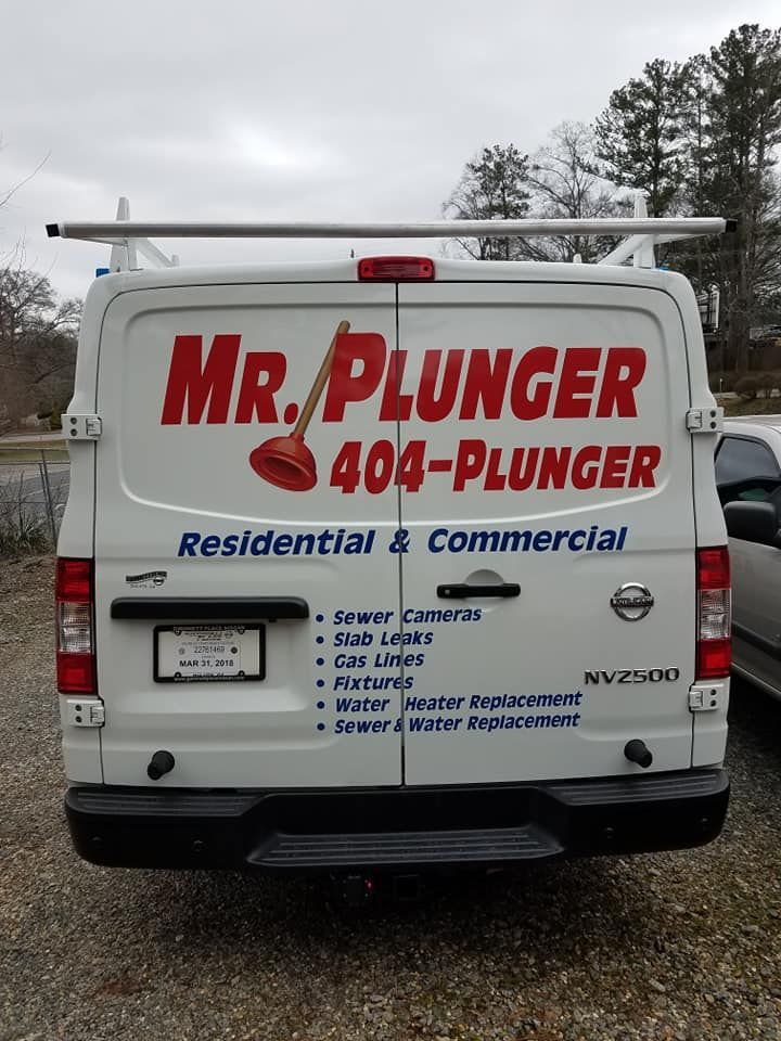 Plumbing worker in orange hard hat and jumpsuit installing pipes. Plumbing worker in orange hard hat and jumpsuit installing pipes.