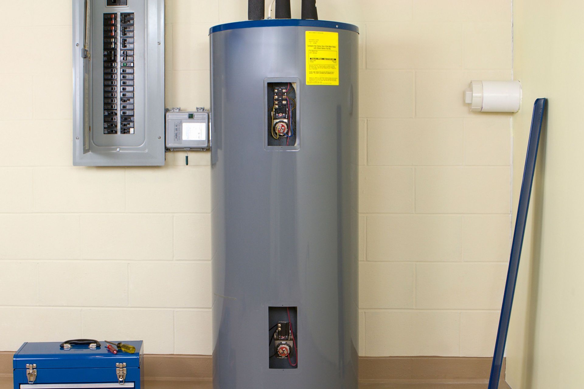 White water heater mounted on a tiled wall. 