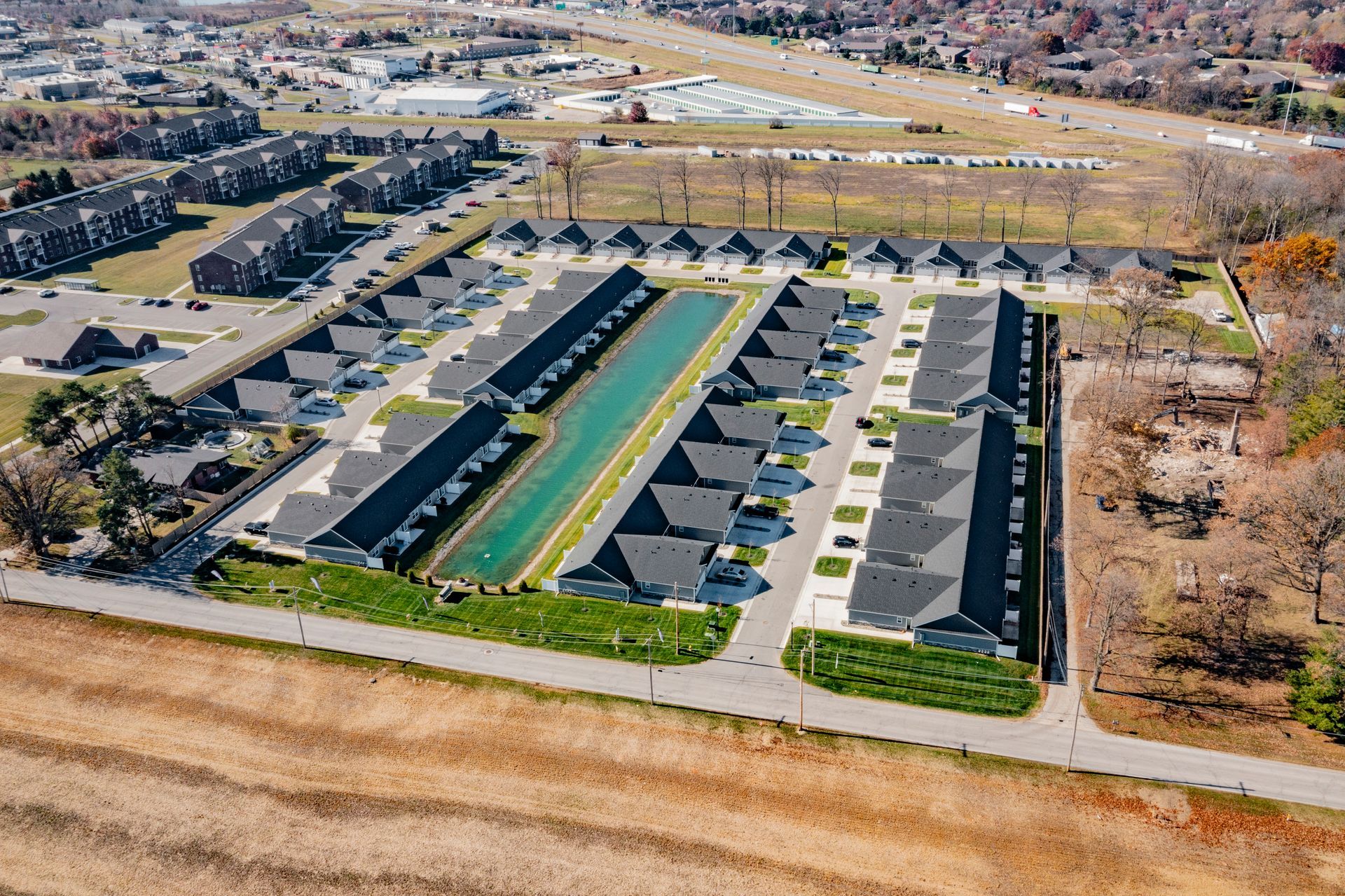 Photo of a row of houses with a small body of water on the property as well