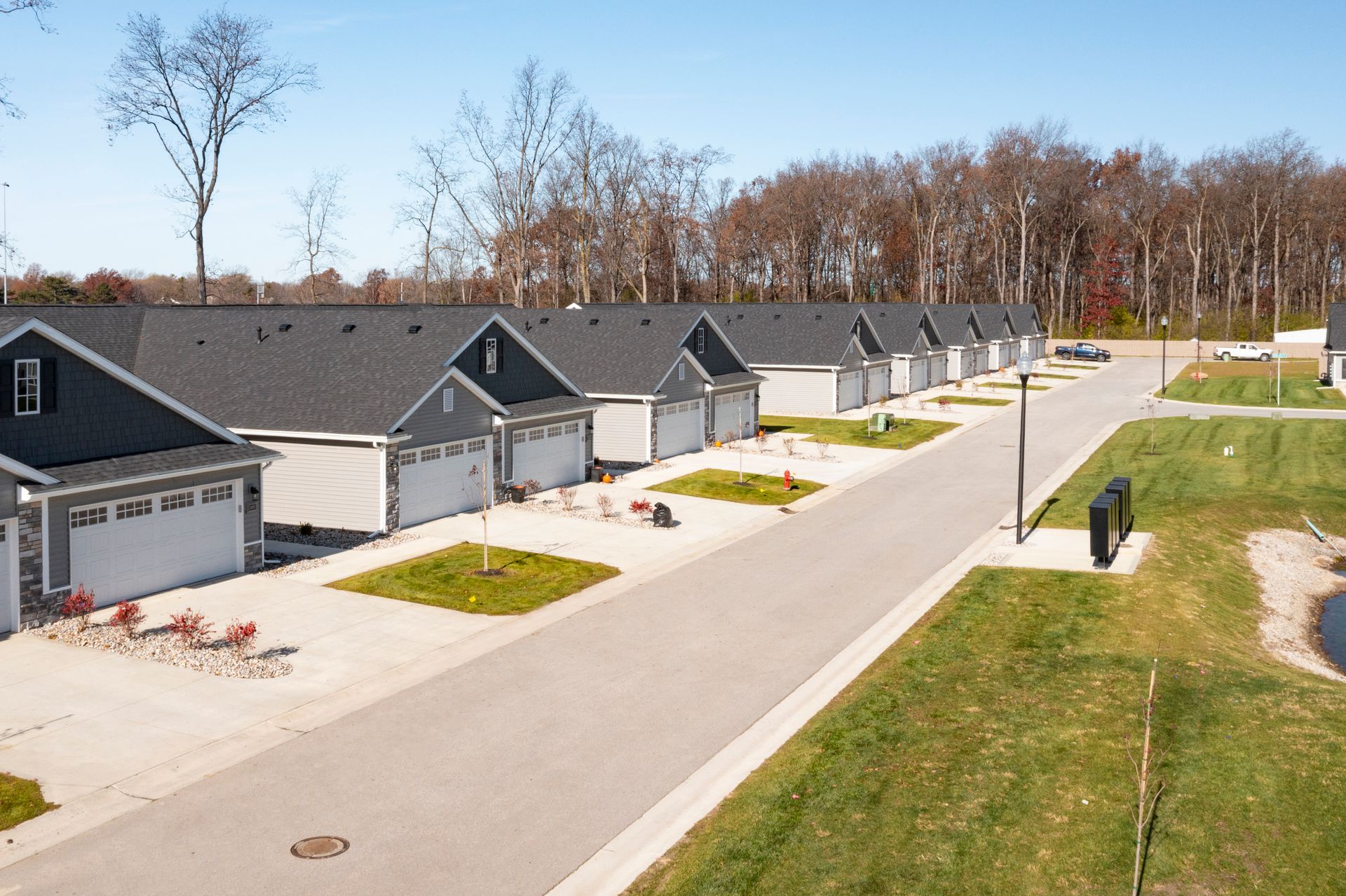 Photo of a row of duplexes showing driveways and garages