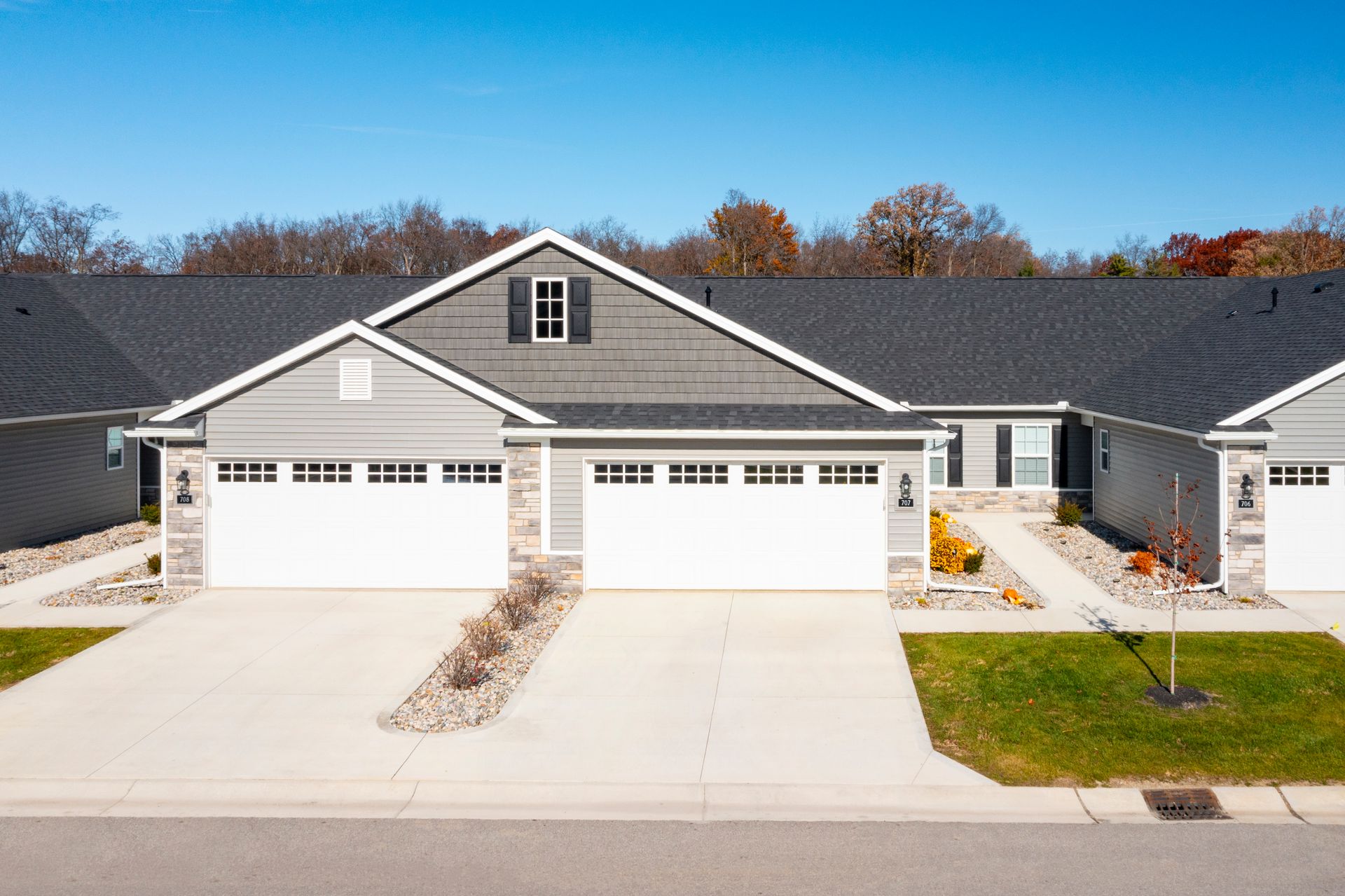 Photo of a set of duplexes with the entrance to two being led to by a short pathway