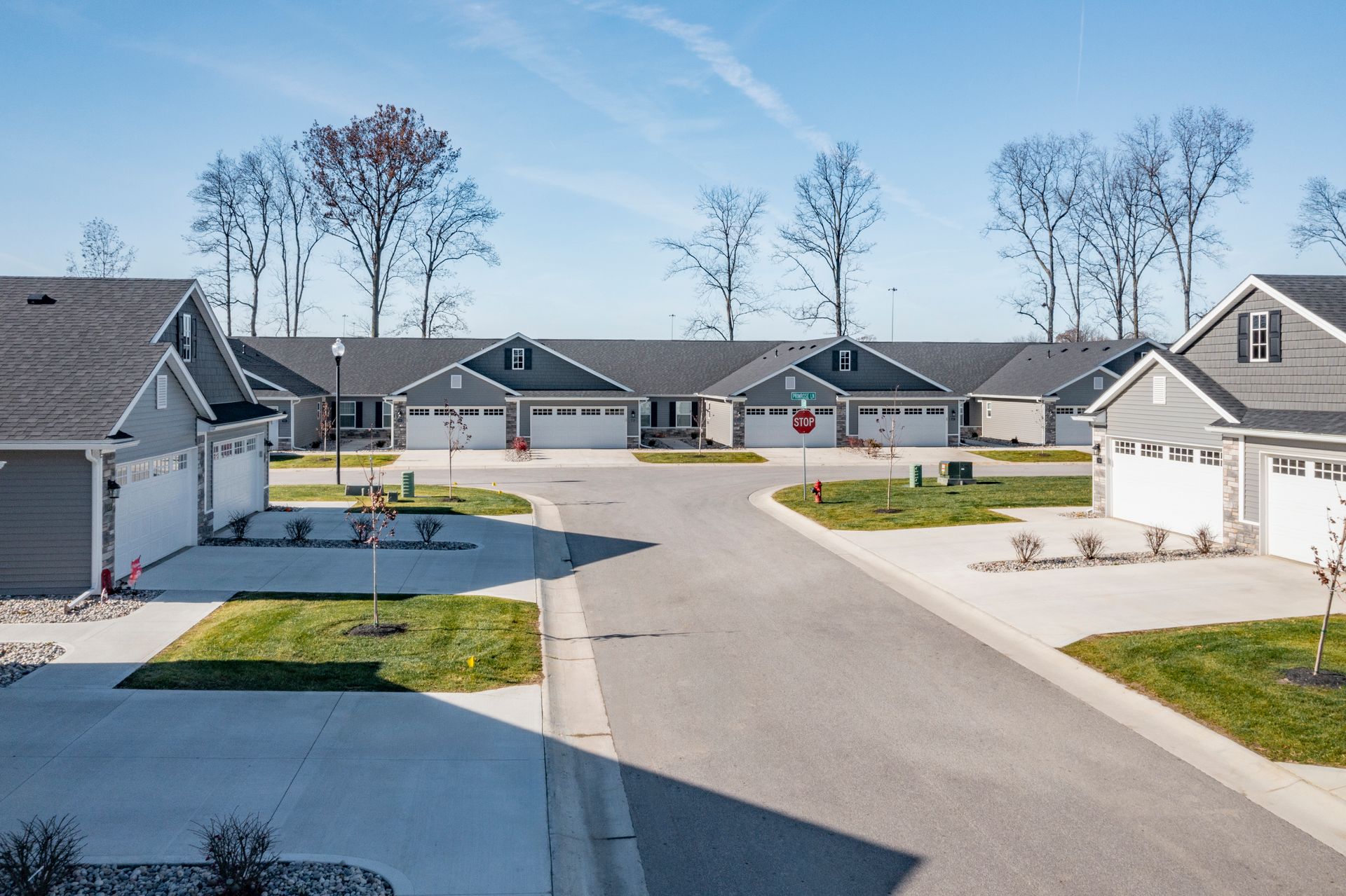 Photo of a street in the community showing duplexes and an intersecting street
