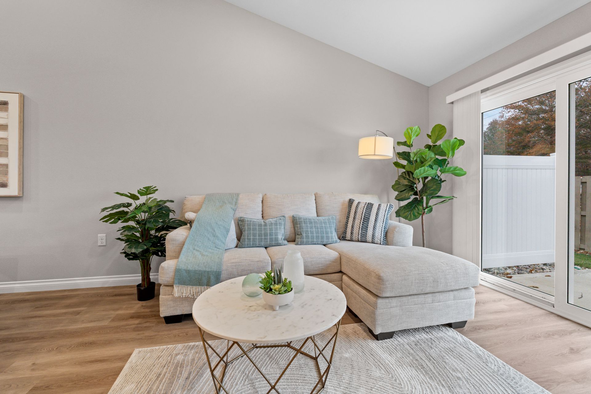 Photo of a couch with an extending piece. To the right side of the photo is a patio