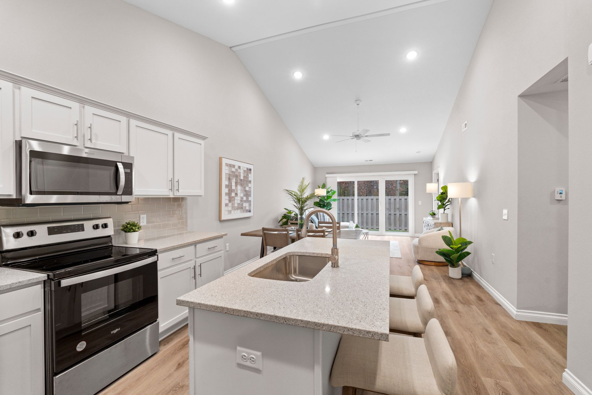 Photo of a kitchen island wide enough for three chairs