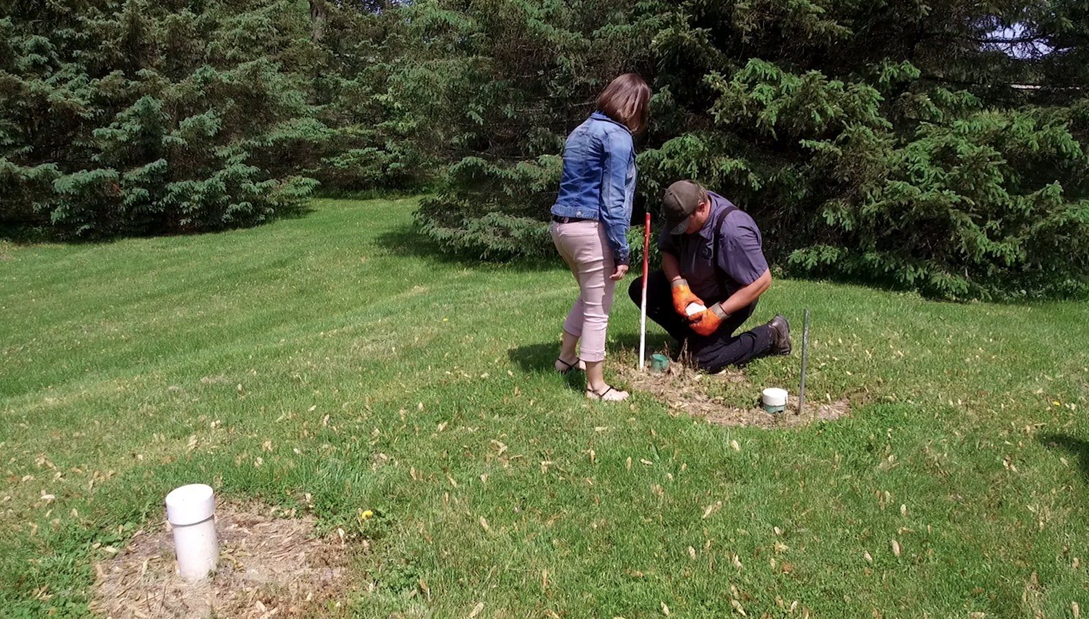 Man and Woman Checking the Septic — Clyman, WI — United Septic & Drain Services Inc