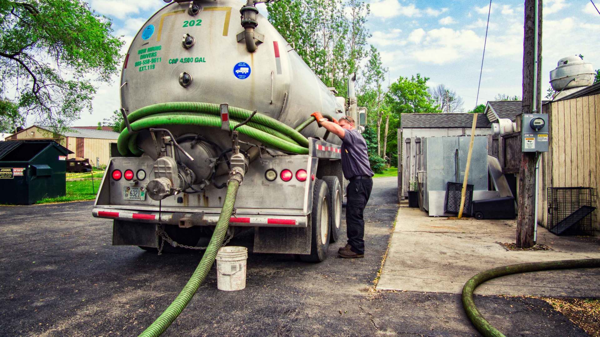 Worker Preparing the Hose from the Truck — Clyman, WI — United Septic & Drain Services Inc