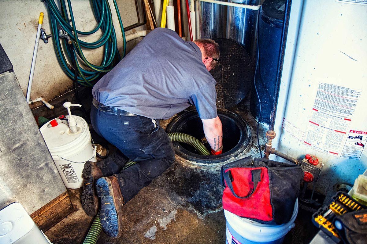 Technician Cleaning the Septic — Clyman, WI — United Septic & Drain Services Inc